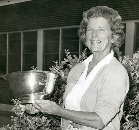 Photo of Jean Arendes Bibby holding tennis trophy bowl