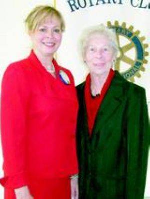 2 women standing in front of Rotary Club sign; Karen Johnson and Doris (Henaghan) Fisher 