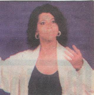 Newspaper article of Debbie Beckward standing making hand gesture