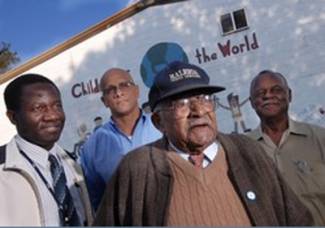 Group of 4 men pause for picture in front of mural in Frederick MD