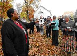 Group of people gather in the fall on rolling landscape in southern Frederick County