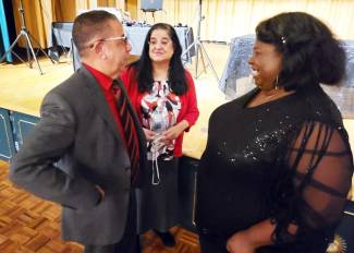 Picture of man and 2 women talking at community event