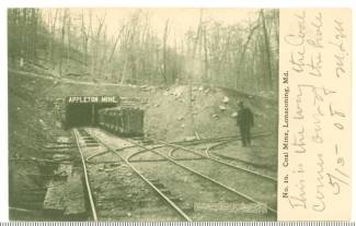 Image of mouth of Appleton mine with 1 worker on track and coal cart