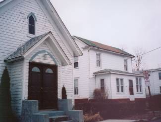 Photo of 2 homes; Dickerson A.M.E. Church on left, Mitchell-Edwards family homestead on right