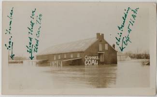 Photo of Cushwa warehouse surrounded by water during 1936 Flood; markings of building written on photo
