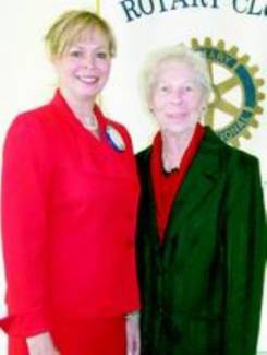 2 women standing in front of Rotary Club sign; Karen Johnson and Doris (Henaghan) Fisher 