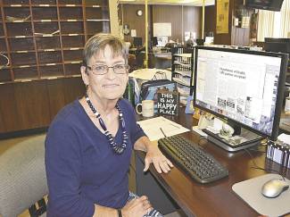 Photo of Debbie Haan at desk in office