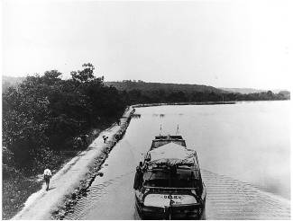 Boat at Big Pool with people walking along tow path; circa unknown
