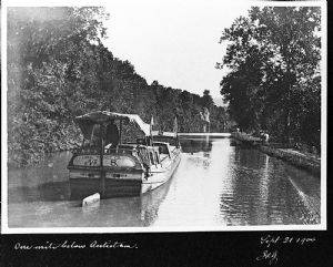 Canal boat traveling down canal