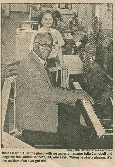 Newspaper clipping of man playing piano with woman standing in background