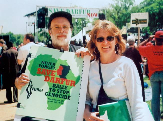 Man with sign "Save Darfur" and woman posing during rally