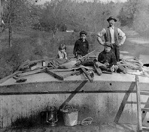 Family of 4 (1 man and 3 children) on top of Canal Boat