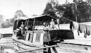 Family on canal boat; clothes hanging on clothe line