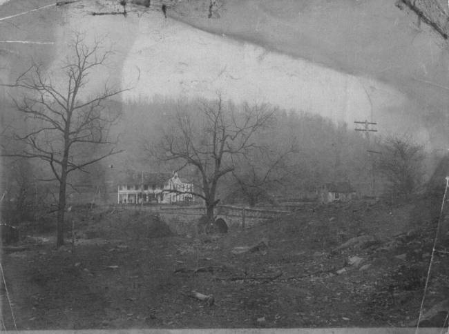 B&W photo of Clarysville Inn in distance near wooded area; 1875