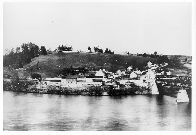 Small community town by water, hotel on hill; Lock 38