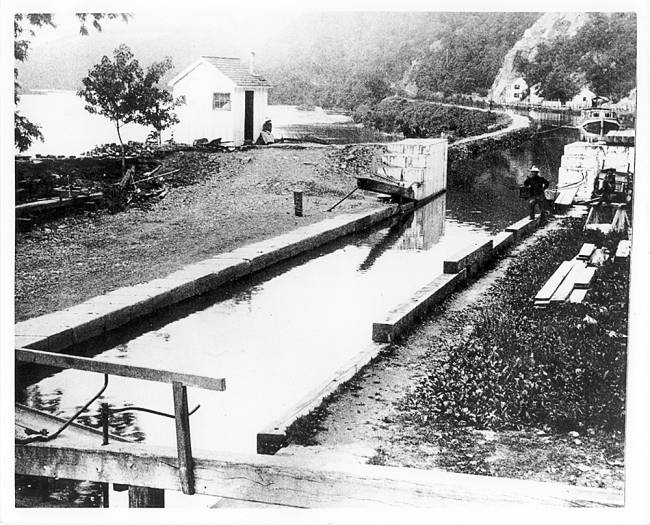Picture of Lock 33, man stands along edge of lock