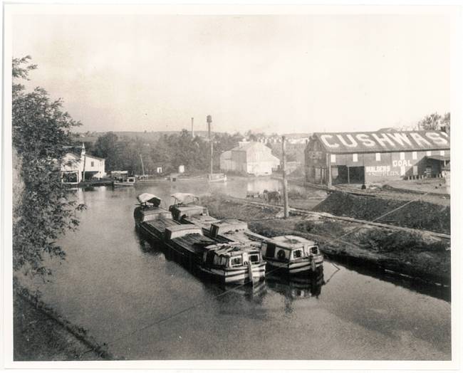 Canal at Williamsport; 2 boats in canal, Cushwas building in the background