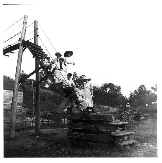 Group of pedestrians sitting on stairs for photo at Snyders Landing, c.1890