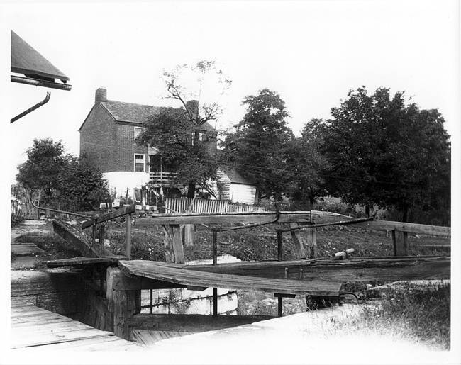 Lockhouse at Lock 49 sets up on hill with picket fence