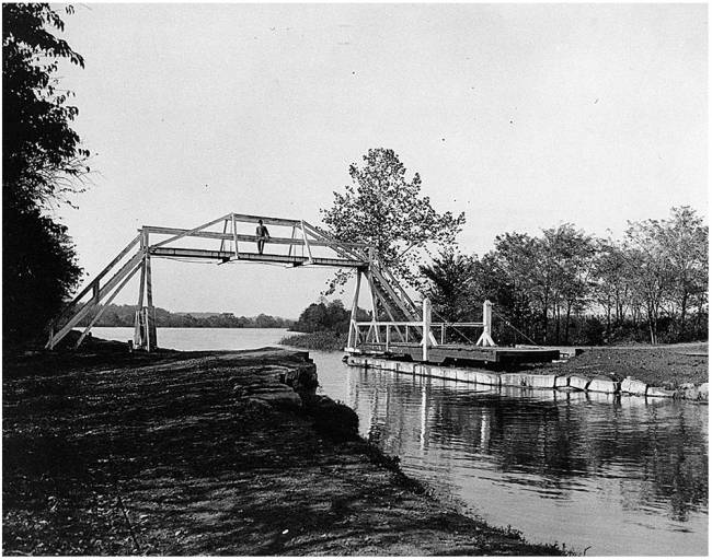 Downstream Big Pool stop gate with pedestrian on footbridge, pivot bridge at bottom