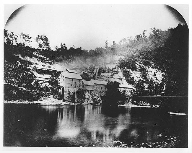 Round Top Cement Mill c. 1871. Smoke is coming from the limestone kilns, photo taken from across the canal