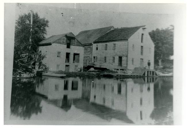 Charles Mills, 2 buildings located on canal, man standing on loading dock