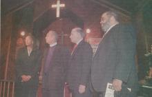4 people standing in front of a church sanctuary for a picture