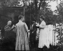 4 people standing around book wagon