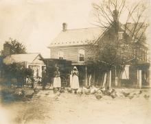 Book wagon with horse 3 people standing in front of a house