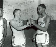 2 basketball players in team uniform making a toast to pop bottles