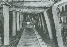 Picture of men in mine shaft on cart
