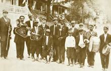 Photo of Luke Band concert; musicians holding their instruments posing for photo in 1906
