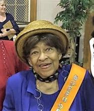 Photo of woman wearing a hat and orange sash