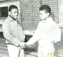 Two young boys shaking hands