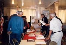 People gathered viewing items from Black History display at Fulton Myers Post #153