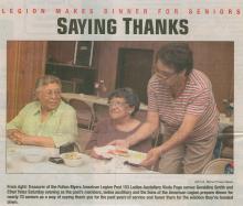 2 women sitting at table for dinner; 1 women serving food to them