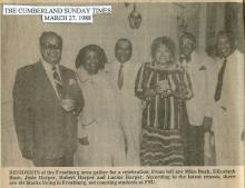 Group of 6 men and women gather for a celebration