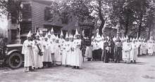 Klu Klux Klan rally; members with white robes and hoods circa 1925