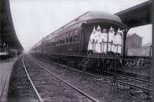 Members of Klu Klux Klan in robes and hood board train in Cumberland MD circa 1925s