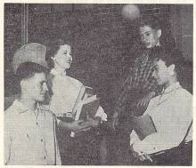 Students at Allegany High School in 1955 greet new integrated students; 4 students in photo, 2 carrying books 