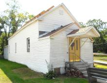 Photograph of church building with yellow front doors