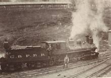 Train car on track with man standing to side