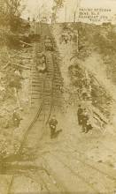 Image of coal tracks and carts with workers at Ocean mine