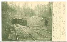 Image of mouth of Appleton mine with 1 worker on track and coal cart