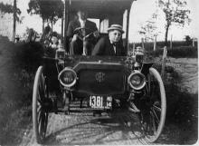 Two men riding in book wagon, circa 1914