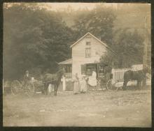 2 horse drawn wagons with people standing going through book wagon books