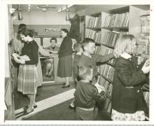 Children inside bookmobile circa 1960s browsing for books