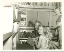 Children visiting inside bookmobile circa 1960s