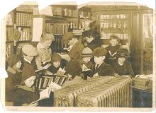 Children gathered in store station reading books