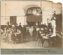 Children sitting at tables reading books at WCFL children's corner